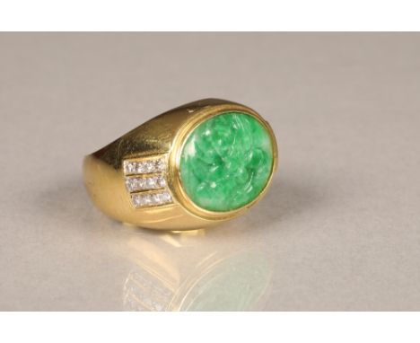 Gents jadeite and diamond ring, unmarked yellow metal mount with inset carved green jadeite stone to centre. Each shoulder is