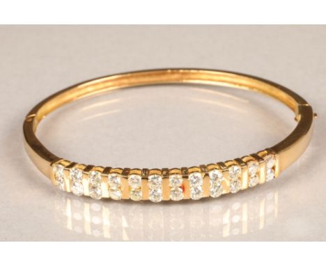 18 carat gold stiff bangle, set with twenty four 0.1 carat brilliant cut diamonds, approximate total 2.4 carats, total weight