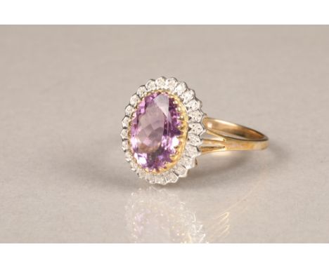 9 carat gold amethyst and diamond cluster ring, central cut amethyst surrounded by 24 diamond chips. Amethyst measures approx