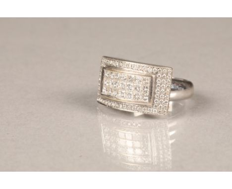 18 carat white gold diamond cluster ring, 21 princess cut diamonds set within a central rectangle, surrounded by 78 small bri