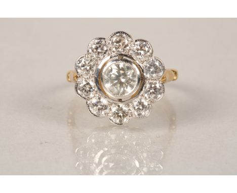 18 carat gold diamond cluster ring, daisy form, centre stone approx. 0.75 carat brilliant cut diamond surrounded with ten 0.1