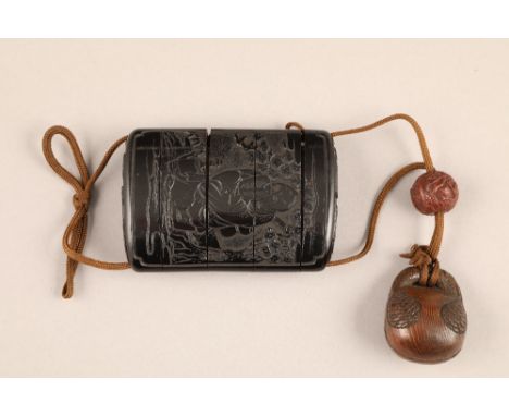 Japanese four case black horn inro, carved figure of an elder in a garden setting, together with ojime bead and carved wooden