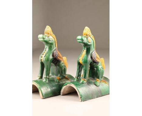 Pair of Chinese roof tiles in the form of heavenly horses in green, brown and yellow glaze, 24.5cm long, 36cm high. CONDITION