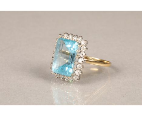 Ladies blue topaz and diamond ring, central blue topaz surrounded by 22 small diamonds on an 18 carat gold shank.  Ring size 