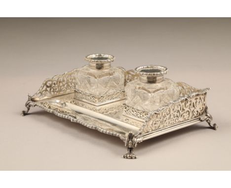 Edwardian silver desk tray, with pierced gallery, twin silver topped ink wells raised on four scroll feet, assay marked Londo