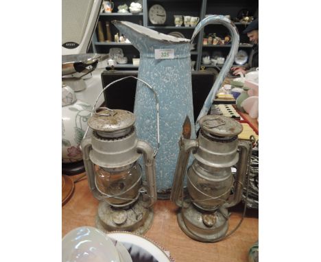 A large enamel water jug and two storm lanterns