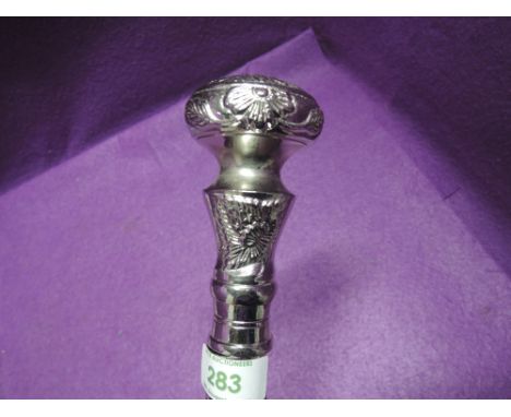 An Indian style wooden walking stick having a white metal moulded knop, unscrews into three pieces