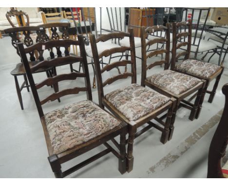 A set of four ladder back dining chairs