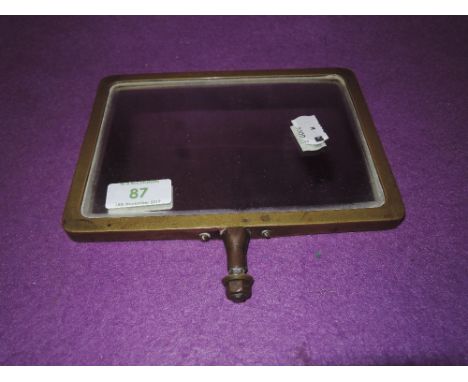 A vintage brass framed shaving or similar mirror by Hunts LTD