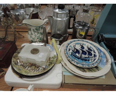 A selection of ceramic display plates and stainless tea wares