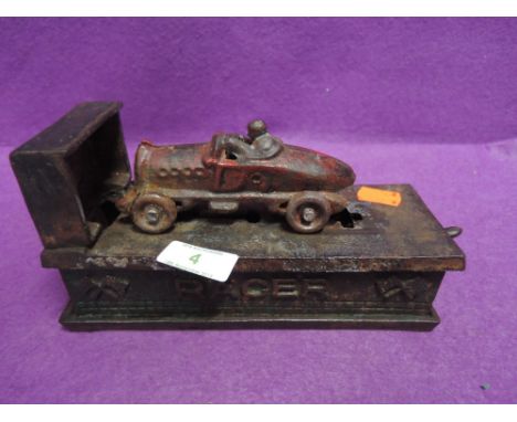 A vintage cast iron money box in the form of a race carin working order, everything present