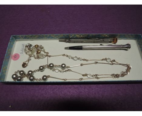 Two vintage yellow wire necklaces having pearl and crystal decoration, a small white metal propelling pencil stamped sterling