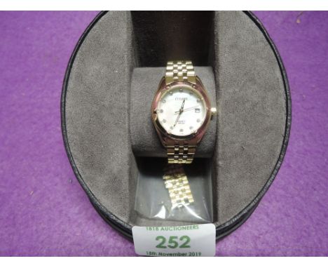 A lady's gold plated wrist watch by Citizen having diamante set dial to mother of pearl face on a gold plated bracelet strap 