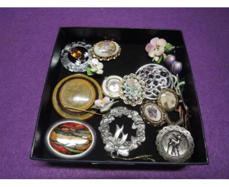 A small selection of costume jewellery brooches, including ceramic and wooden, a pendant watch and a pewter Xmas wreath decor