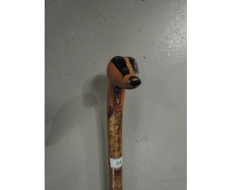 A hand carved Silver birch walking stick with badger head handle