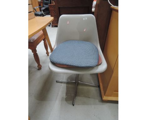 A vintage swivel plastic chair