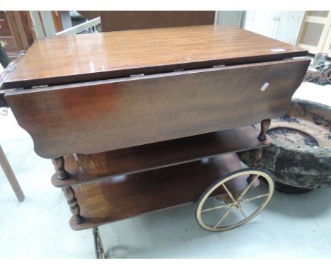 A vintage tea trolley of cartwheel design