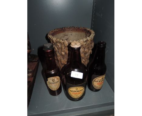 A selection of vintage Guinness beer bottles and planter