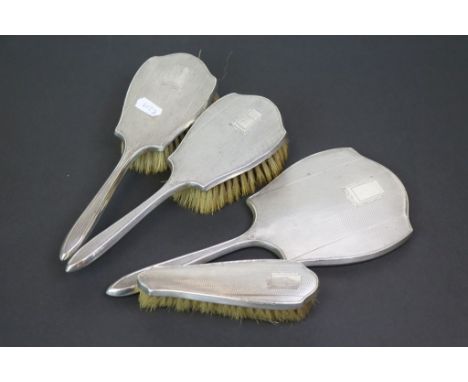George VI four piece silver back dressing table brush set, engine turned decoration with blank cartouche, makers Daniel Manuf