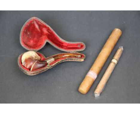 Meerschaum pipe, the bowl fashioned as an oriental head, white metal collar, amber type mouth piece (af), cased together with