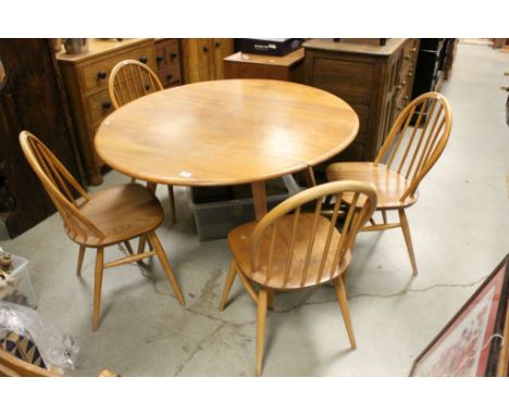 Ercol Light Elm Oval Drop Flap Dining Table together with Four Ercol Elm Seated Hoop Back Dining Chairs