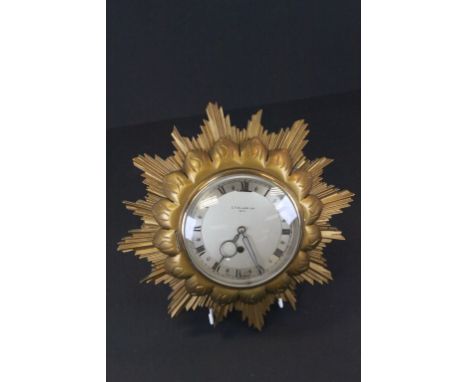 Key wind Sunburst wall Clock with silvered dial marked "C.T Gilmer Ltd Bath"