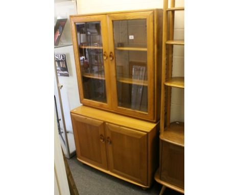 Ercol Light Elm Bookcase / Cupboard comprising Upper Bookcase Section with Glazed Doors above a Two Door Cupboard, 161cms hig