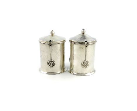 By A. E. Jones, a pair of Arts & Crafts silver jam pots, Birmingham 1938, circular form, spot-hammered and applied rope-twist