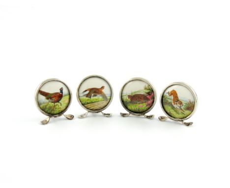 A set of four silver menu card holders, by Grey and Co, Chester 1911, circular form, set with watercolour panels of a pheasan