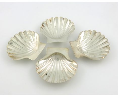 A set of four George III silver butter shells, by Robert Garrard, London 1822, shell form, engraved with a crest, with two sh