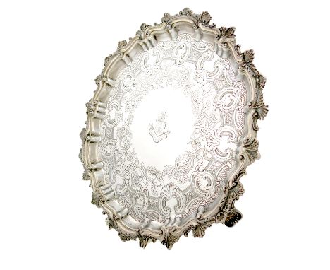 An Edwardian silver salver, by Thomas Bradbury, London 1902, circular form, scroll and shell border, the centre with chased f