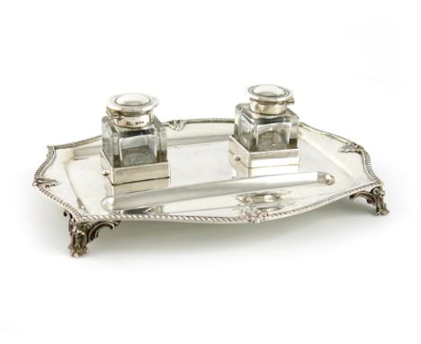 A silver inkstand, by The Goldsmiths and Silversmiths Company, London 1911, shaped rectangular form, gadroon border, with a p