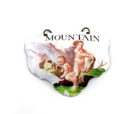 A rare mid 18th century Battersea enamel wine label, circa 1755, escutcheon form, with two cupids in a rocky landscape, title