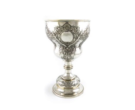 A large Victorian silver trophy goblet, by Robert Garrard, London 1873, baluster shaped bowl with embossed foliate and shell 