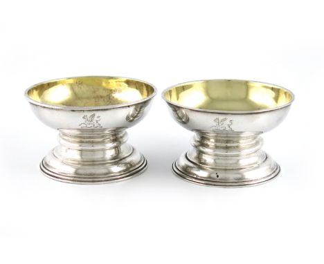 A matched pair of George III silver salt cellars, by Robert Garrard, London 1812 and 1817, circular form, gilded bowls, on ra