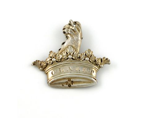 A Victorian silver-gilt armorial wine label, by Robert Garrard, London 1864, modelled as a claw issuing from a crown, incised
