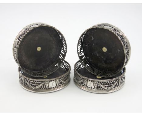 λA set of four George III silver wine coasters, maker's mark partially lost in piercing, London 1775, circular form, pierced 