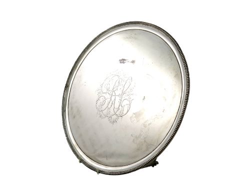 A George III silver salver, by Crouch and Hannam, London 1787, circular form, the centre with a large initial, with foliate m