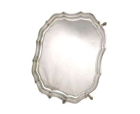 A silver salver, by Frederick Wilson & Co., London 1913, shaped square form, moulded border, on four scroll bracket feet, dia