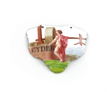 A rare mid 18th century Battersea enamel wine label, circa 1755, escutcheon form, with cupid and a cider press, titled 'CYDER