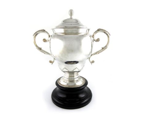 A two-handled silver trophy cup and cover, by D and J Wellby, London 1914, baluster form, beaded scroll handles, wavy borders