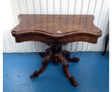 Walnut carved turnover twist top card table with leather insert on carved tripod legs on castors, 36" d x 18" closed (36" ope