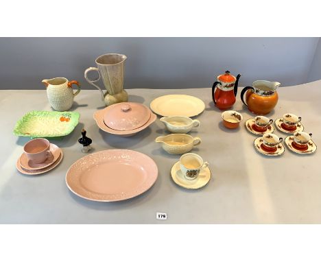 11 pieces of Clarice Cliff ware - pink cup, saucer, side plate, oval platter &amp; lidded tureen, yellow jug, cream platter a