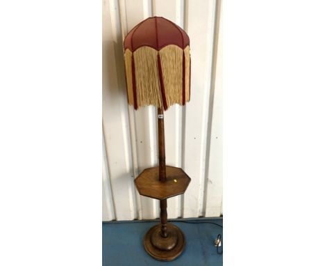 Carved wooden standard lamp with tray and fringed lampshade, 65"high