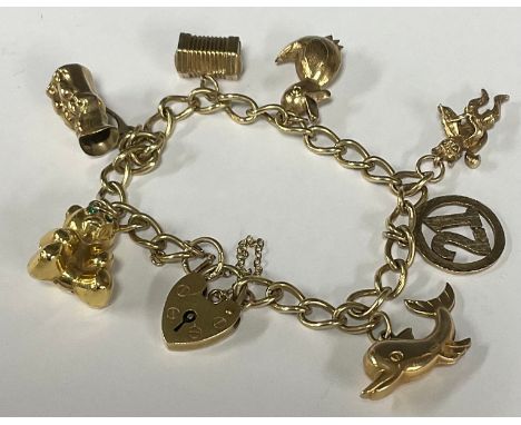 A 9ct gold charm bracelet, with dolphin, toby, bear, padlock clasp, 20g