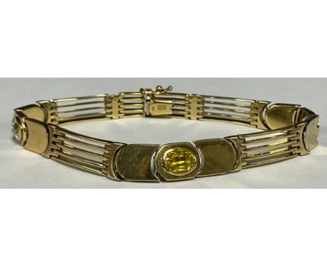 A 9ct gold gate bracelet, fancy link set with semi precious stones.