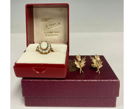 A 9ct gold Cz and opaline cabochon dress ring, 9ct gold shank, size M, 2.9g gross;  a pair of seed pearl 9ct gold earrings, 2