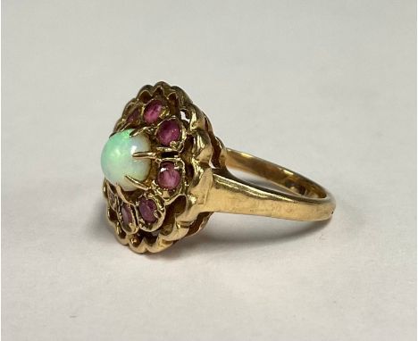 An opal and pinky spinel flower head cluster ring, central cabochon opal, stone blue green play, surrounded by eight pink spi