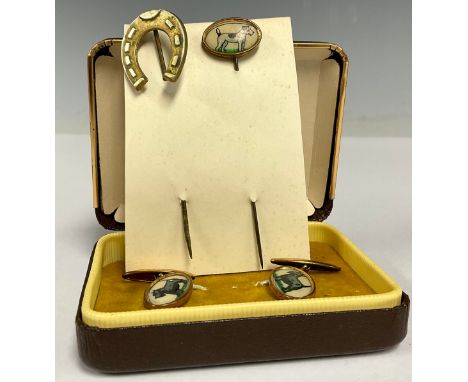 A pair of mid-century brass and enamel cuff links, decorated with Scottish terriers, cased; an associated stick pin, 8cm long