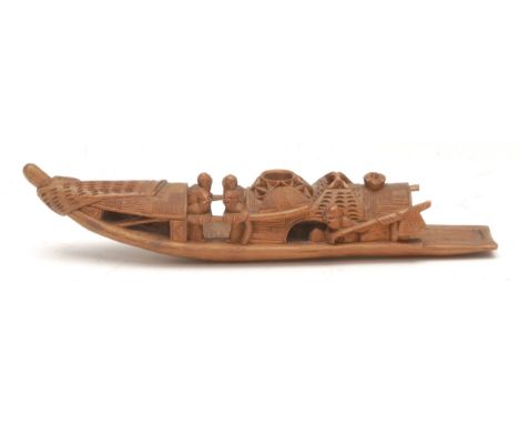 An early 20th century Cantonese bamboo calligraphy brush tray, as a cargo boat carrying silks and scholars, 23cm long, Qing D